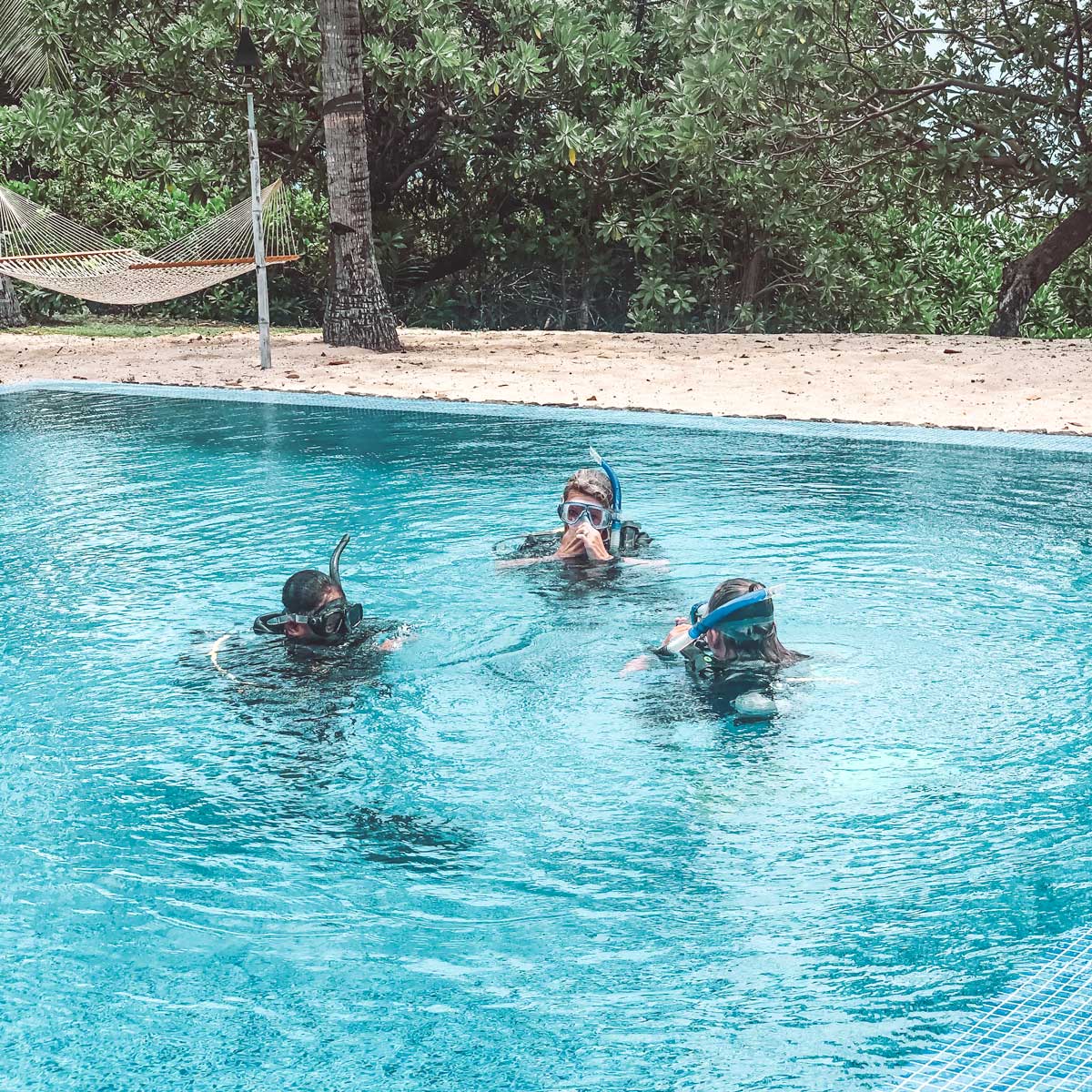 Hackett family learning to dive in the pool at the palms private residence before venturing into vomo open waters
