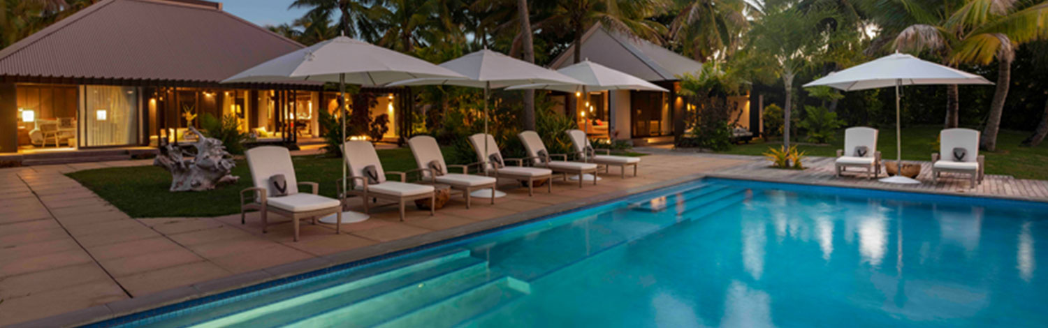 The residence luxury accommodation vomo island fiji pool area at twilight