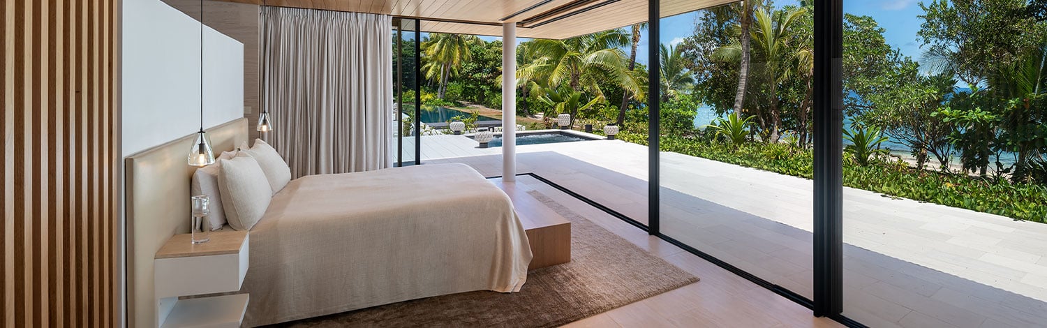Vomo the reef house master bedroom with views to pool and ocean steps away